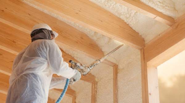 Editorial illustration for Choosing Attic Insulation: How R-Value, Cost, and Climate Zone Determine the Right Material